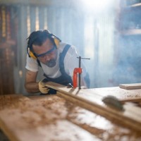 mature man cutting wood in workshop - home decoration stock pictures, royalty-free photos & images