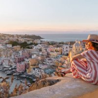 mature woman admiring procida sunset cityscape - travel stock pictures, royalty-free photos & images