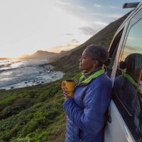 mature woman enjoying sunset by the sea - travel stock pictures, royalty-free photos & images