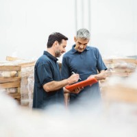mature workers taking inventory of packaged meat in the warehouse - food stock pictures, royalty-free photos & images