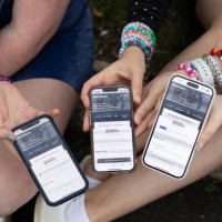 May 13: Anna Mason, Emily Lind, and Kristen Robinson show their Ticketmaster queue, which displays over 2000+ people ahead of them, from the parking...