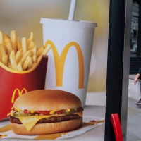 McDonalds double cheeseburger saver meal deal menu beef burger advertising poster on 6th July 2023 in London, United Kingdom.