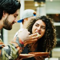 medium close up shot of woman eating tacos with friends at food truck - food stock pictures, royalty-free photos & images