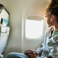 medium shot of girl looking out window of commercial airplane - travel stock pictures, royalty-free photos & images