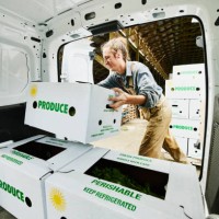 medium shot of smiling farmer putting freshly packed csa boxes into delivery van - food stock pictures, royalty-free photos & images