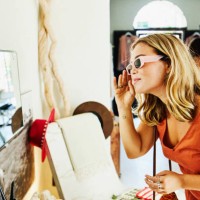 medium shot of woman trying on sunglasses while shopping during vacation - fashion stock pictures, royalty-free photos & images