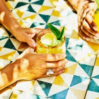 medium shot of womans hands holding margarita at table in beach cafe - food stock pictures, royalty-free photos & images