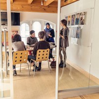 meeting in small creative start-up enterprise lead by woman. - fashion stock pictures, royalty-free photos & images