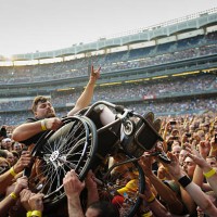 Megadeth fan in a wheelchair is hoisted for a better view during 
