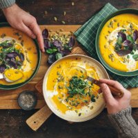 men eating vegan creamy roasted pumpkin soup - food stock pictures, royalty-free photos & images