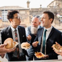 men enjoying food from a food truck - junk food stock pictures, royalty-free photos & images