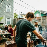 men grilling food for friends during backyard barbecue - garden decoration photos et images de collection