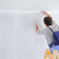 men painting empty home interior - home decoration stock pictures, royalty-free photos & images