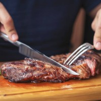 men's hands holding knife and fork, cutting grilled steak - food stock pictures, royalty-free photos & images