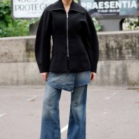 Meredith Duxbury wears black jacket, blue denim pants, black heels, outside Ganni, during Womenswear Spring/Summer 2025 as part of Paris Fashion Week...