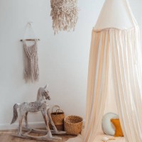 messy children's playroom full of toys. beautiful decoration nursery with natural macrame decoration, organic canopy, wicker baskets and wood toys. vertical photo. - home decoration stock pictures, royalty-free photos & image