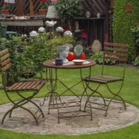 metal table and two chairs on a stone slab in the garden, decorated with a bust and small lamps, borken, münsterland, germany - garden decoration stock pictures, royalty-free photos & images
