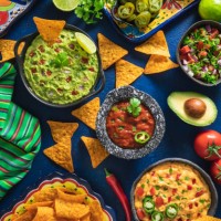 mexican dip sauces guacamole, cheedar dip, tomato salsa and pico de gallo with nacho chips - food stock pictures, royalty-free photos & images