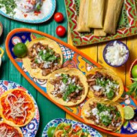 mexican festive food for independence day independencia - chiles en nogada, tacos al pastor, chalupas pozole, tamales, chicken with mole poblano sauce. colorful background, top view - food stock pictures, royalty-free photos 