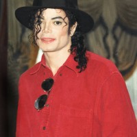 Michael Jackson poses at a press conference before a date on his HIStory world tour in 1996.