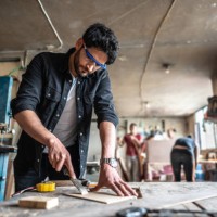 mid adult carpenter carving wood with chisel and hammer at carpentry - home decoration stock pictures, royalty-free photos & images