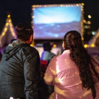 mid adult couple watching a movie at the outdoors cinema - concert stock pictures, royalty-free photos & images