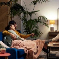 mid adult couple watching tv in living room - home decoration stock pictures, royalty-free photos & images