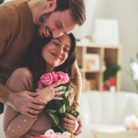 mid adult man giving his girlfriend flowers and gift - home decoration stock pictures, royalty-free photos & images