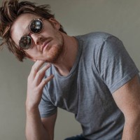 mid adult man with head cocked wearing sunglasses - fashion stock pictures, royalty-free photos & images