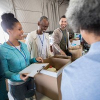 mid adult woman enjoys organizing food bank donations - food stock pictures, royalty-free photos & images