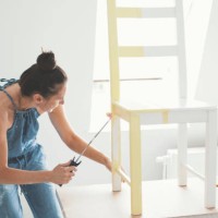 mid adult woman painting chair - home decoration stock pictures, royalty-free photos & images