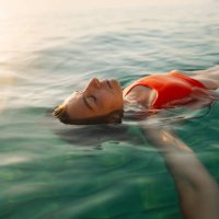 mid adult woman swimming in the calm sea water - travel stock pictures, royalty-free photos & images