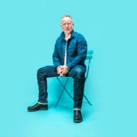 middle-aged man sitting on chair in studio - fashion stock pictures, royalty-free photos & images