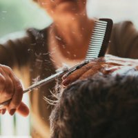 midsection of female barber cutting male customers hair - hairstyle fotografías e imágenes de stock