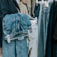 midsection of female owner holding jeans coathanger - fashion stock pictures, royalty-free photos & images