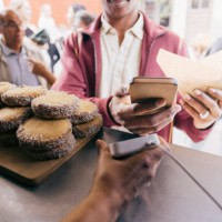 midsection of male customer paying through smart phone at food festival - junk food stock pictures, royalty-free photos & images