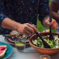 midsection of man mixing salad at table during garden party - garden decoration stock pictures, royalty-free photos & images