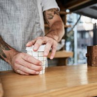 midsection of salesman packing disposable coffee cup in food truck - junk food stock pictures, royalty-free photos & images
