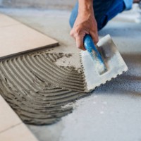 midsection of senior man laying tile floor in new home. - home decoration stock pictures, royalty-free photos & images