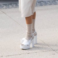 Millan Delaroiere wears Chanel shoes and shorts and camel wool socks outside the Chanel show during Womenswear Spring/Summer 2025 as part of Paris...