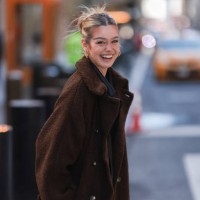 Millane Friesen is wearing a blue denim jeans, a grey hoodie and a brown long coat during New Yorker Fashion Week on February 15, 2022 in New York...