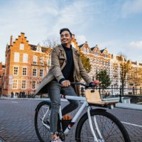 millennial asian tourist in the city with bicycle - travel stock pictures, royalty-free photos & images