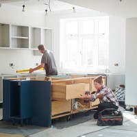 mixed gender kitchen fitters - home decoration stock pictures, royalty-free photos & images