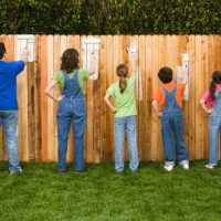 mixed race family painting fence - garden decoration stock pictures, royalty-free photos & images