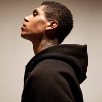 mixed race man with tattoo wearing hooded sweatshirt - fashion stock-fotos und bilder