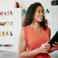 mixed race woman working in shoe store - fashion stock pictures, royalty-free photos & images