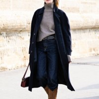 Model Ieva Palionyte is seen wearing a black coat, gray sweater, blue jeans and brown cowboy boots outside the Dior show during the Womenswear...