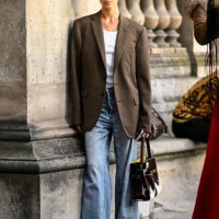 Model is seen wearing a brown blazer and white top, blue jeans cow print bag and black sunglasses outside the Louis Vuitton show during Womenswear...