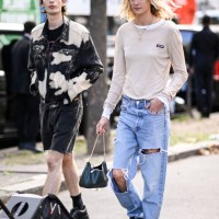 Model is seen wearing a cream Miu Miu shirt, ripped jeans and Prada bag outside the Miu Miu show during the Womenswear Spring/Summer 2024 as part of...