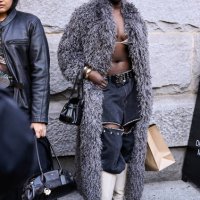 Model Nyandeng Makur is seen wearing a faux for gray coat, black cut out jeans, cream boots outside the Coach show during NYFW F/W 2025 on February...